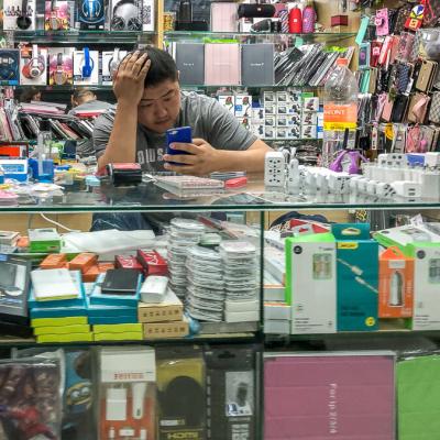 Saopaolo Indoor Market Stall Counter Salesman Checking Phone900