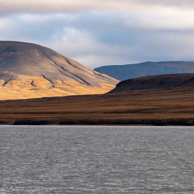 Svalbard Seaview Sunlit Valley Mosscovered Mountains Clouds900 Svalbard Seaview Sunlit Valley Mosscovered Mountains Clouds900
