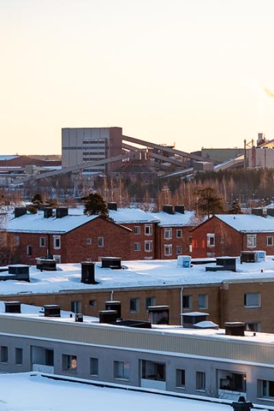 Snowcovered rooftops of residential area with the industry SSAB in the background in Luleå, Sweden Se Lulea Rooftopsresidential Area Iron Industry Smokestacks